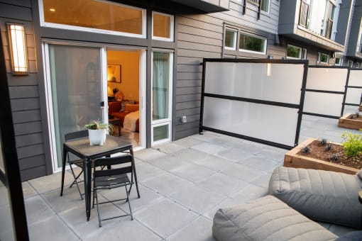 a patio with sliding glass doors and a table