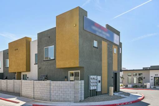A modern building with a combination of beige and grey exterior walls.