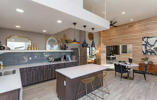 A modern kitchen with a large island and a dining area.