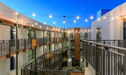 A modern building with a glass atrium and balconies.