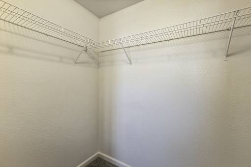 A white wall with a metal rack on it.