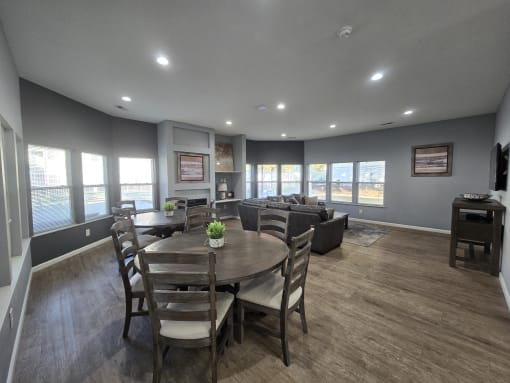 a dining room with a table and chairs and a living room with couches