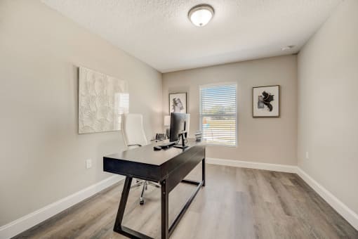 Houses in Lady Lake for Rent – The Groves at Lake Ella - an office space with desk and chair and window.