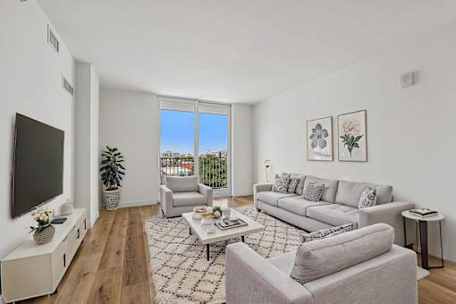 Modern open-concept living room in a pet-friendly one-bedroom apartment at Riverview One Apartments in Downtown Miami near Brickell, the Miami River, Miami Worldcenter, and the Health District.