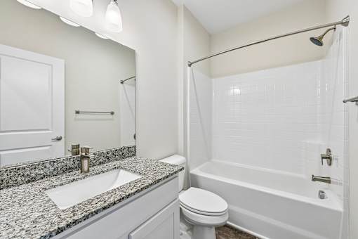 white Hawks Landing bathroom in Hickory NC featuring a sink, toilet, and bathtub