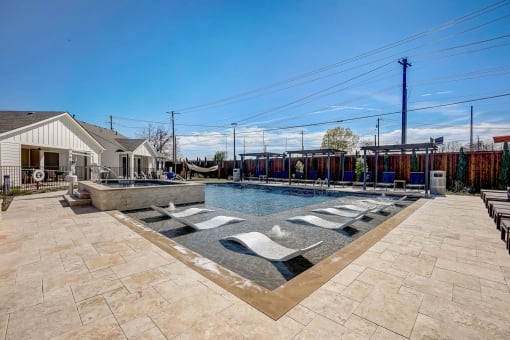 the preserve at ballantyne commons pool and spa with lounge chairs and a pool