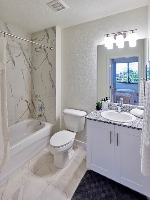 Bathroom with a premium tub and shower combo, featuring clean lines and upscale fixtures at Gateway Luxury Apartments.