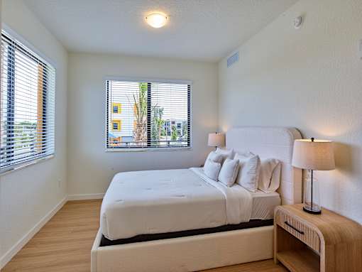 Bright bedroom with a large window providing plenty of natural light, modern finishes, and a cozy layout at Gateway Luxury Apartments.