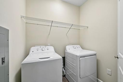 A bright Hawks Landing laundry room in Hickory NC featuring a washer and dryer