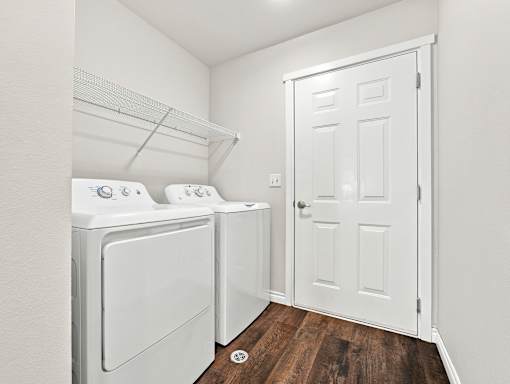 A small laundry room with a washer and dryer.
