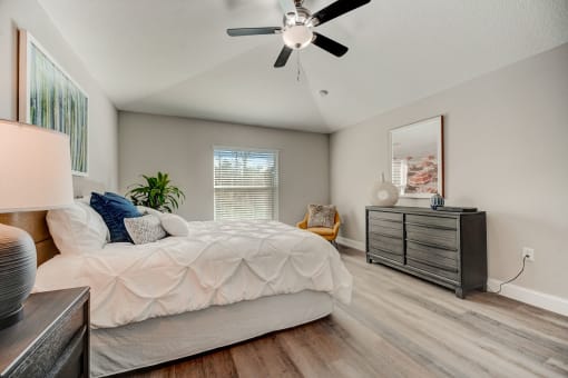 Lady Lake, FL Rentals – The Groves at Lake Ella - the master bedroom has a large bed and a ceiling fan