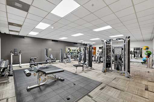 A gym with a variety of equipment including a leg press machine.