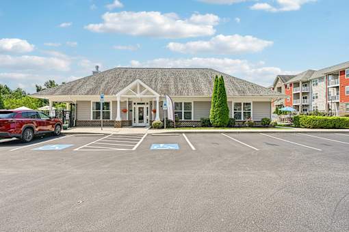 A parking area at the Hawks Landing leasing office in Hickory NC with a tree in the background