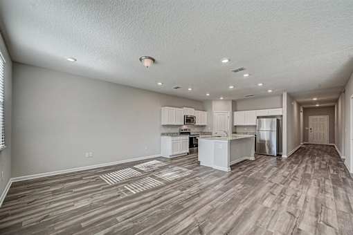 an empty kitchen and living room