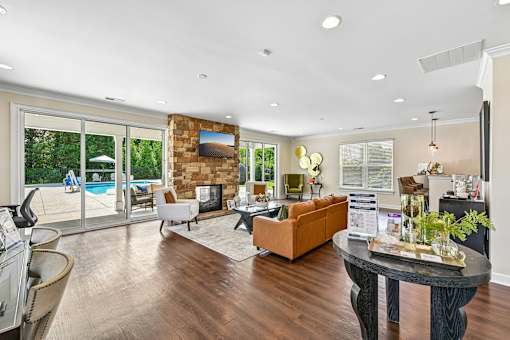 A stylish Hawks Landing clubroom in Hickory NC featuring a fireplace with views of the pool outside