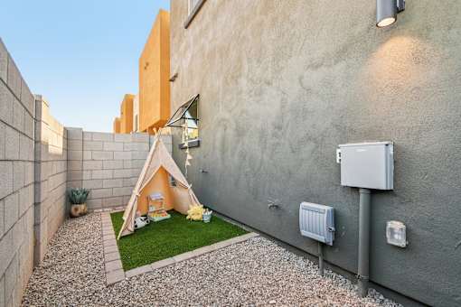 A small tent is set up in a courtyard between two buildings.