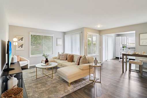 Spacious living room with neutral décor and large windows at Ashford at Geneva – pet-friendly apartments in Geneva, IL 60134