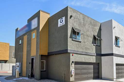 A modern building with a garage door and a sign that reads "C 43-19".