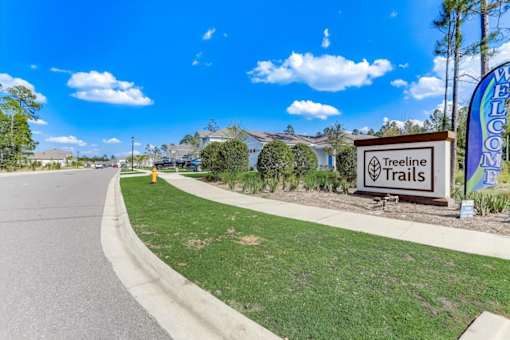 a street with a sign that reads treeline trails