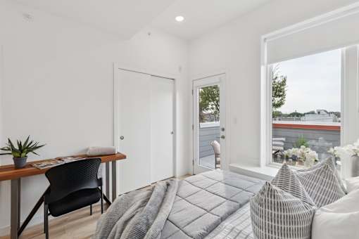 A modern living room with a grey sofa and a wooden table.