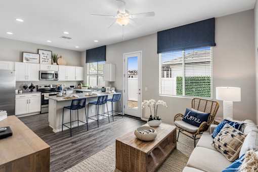 A modern kitchen with a dining area and a living room.
