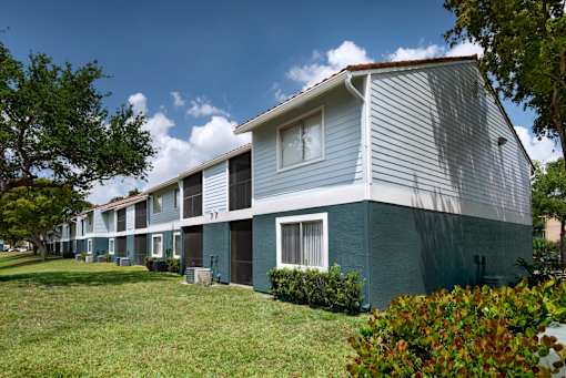 A row of houses with green trim.