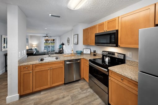 A kitchen with wooden cabinets and stainless steel appliances.
