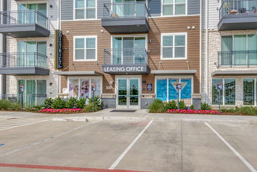 A building with a leasing office sign in front of it.
