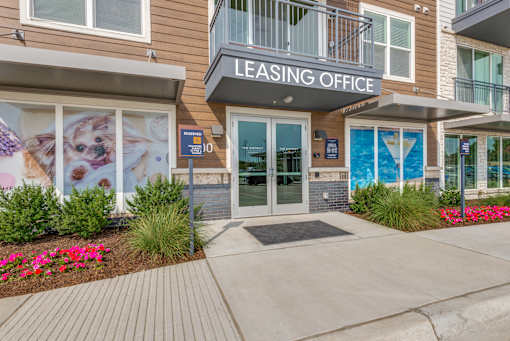 A building with a leasing office sign on the front.