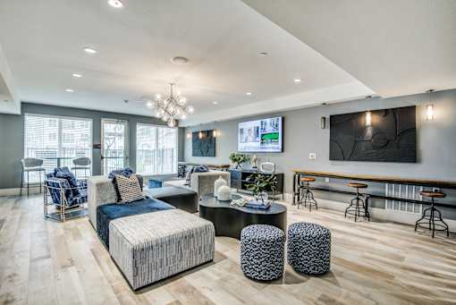 A modern living room with a large couch and a television.