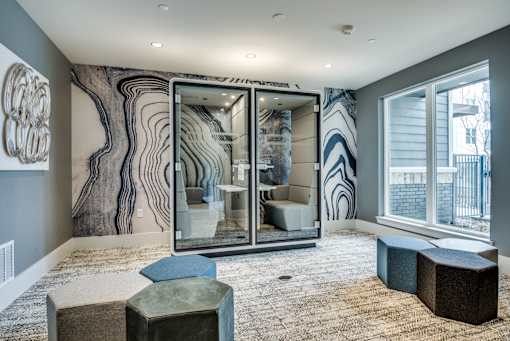 A room with a large mirror and a blue and white patterned wallpaper.