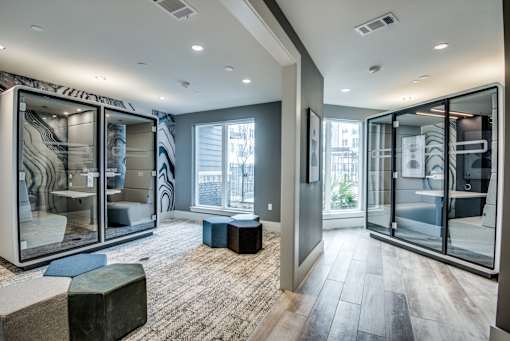A modern room with a glass walled cabinet and a bench.