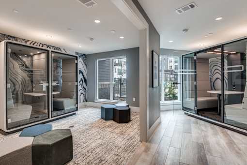 A modern room with glass walls and a wooden floor.