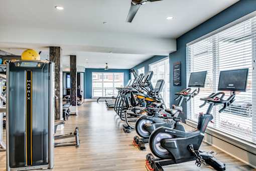 A gym with exercise equipment and a window.