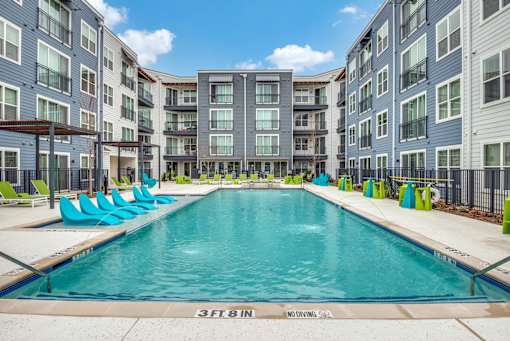 A swimming pool surrounded by residential buildings.