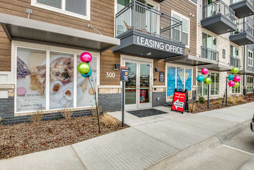 A leasing office for apartment 300 is shown with a sign that reads "The District Simplified.".