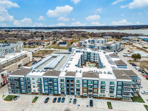 A large, multi-story building with a parking lot in front.