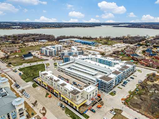 A large building complex with a parking lot in front of it.