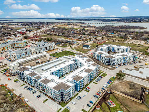 A large building complex with a parking lot in front.