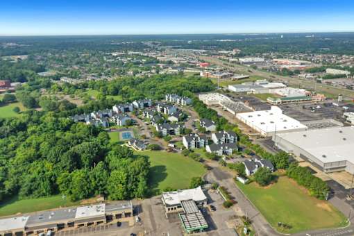 An aerial view of a town with a mix of residential and commercial buildings.