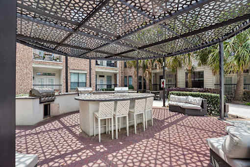 A patio with a table and chairs under a canopy.