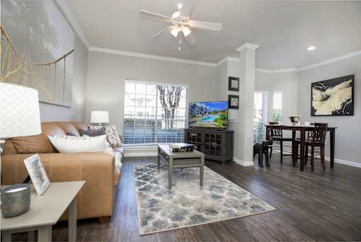 an open living room and dining room with a ceiling fan