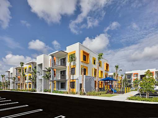 Gateway Luxury Apartments building exterior featuring modern architecture and an adjacent playground.