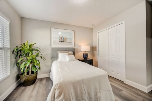 Houses in Lady Lake for Rent – The Groves at Lake Ella - guest bedroom with hardwood floors and a bed