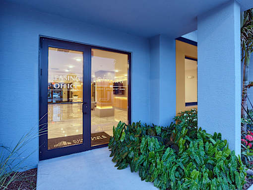 Front exterior of the leasing office building at Gateway Luxury Apartments with clear signage and greenery.