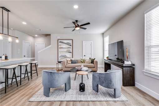 A modern living room with a grey sofa and a grey coffee table.