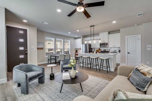 A modern living room with a grey sofa and a coffee table.