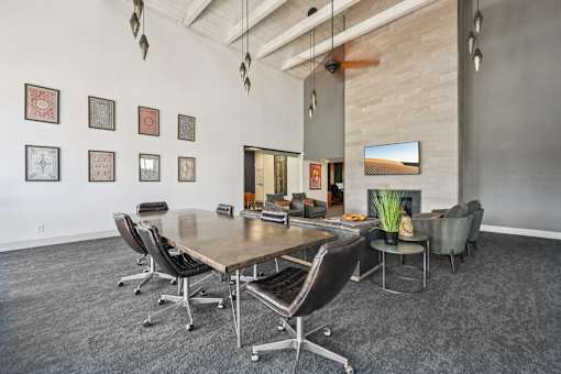 A conference room with a long table and chairs.