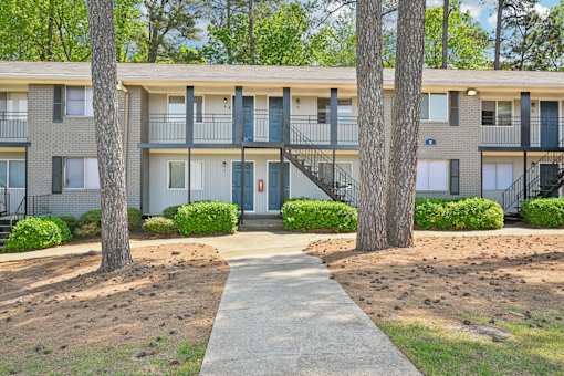 Apartment building exterior at Amber Grove in Marietta Georgia with mature landscaping