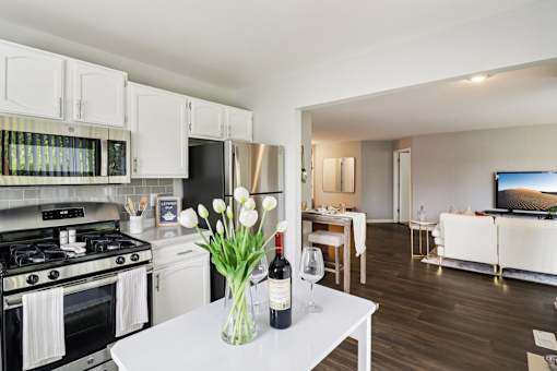 Modern kitchen with stainless steel appliances and white cabinetry at Ashford at Geneva Apartments in Geneva, IL – pet-friendly homes in the Far Northwest Chicago Suburbs